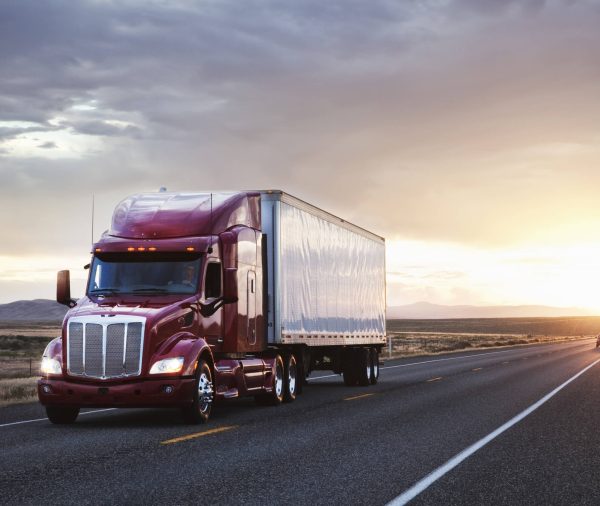 3/4 front view of a commercial truck on the road at sunset  in eastern Washington, USA